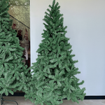Load image into Gallery viewer, Tall artificial Christmas tree against a white wall