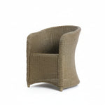Load image into Gallery viewer, Wicker chair in a room with white walls and a concrete floor.