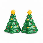Load image into Gallery viewer, A pair of small green Christmas tree-shaped salt and pepper shakers with gold star toppers, set on a gray stone surface against a textured beige wall.