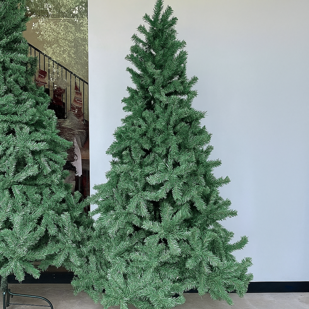 Tall artificial Christmas tree against a white wall