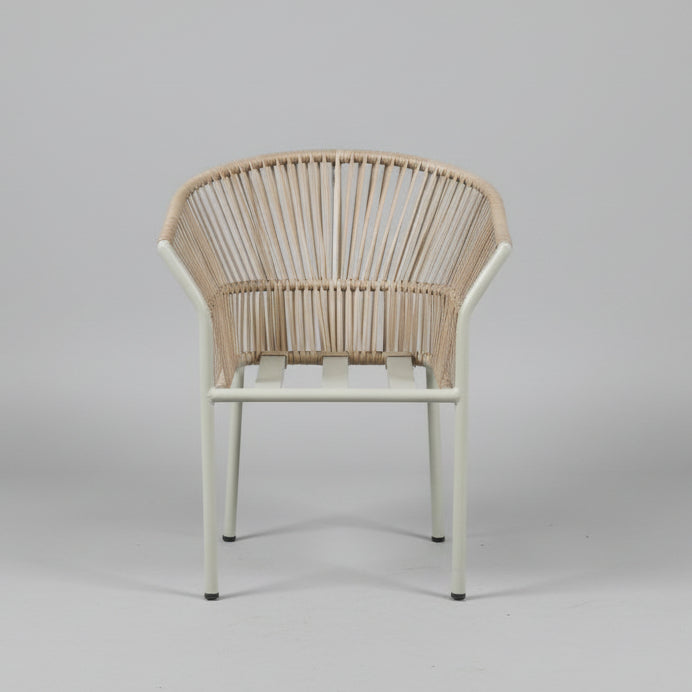 Wicker chair against a white wall with construction materials around