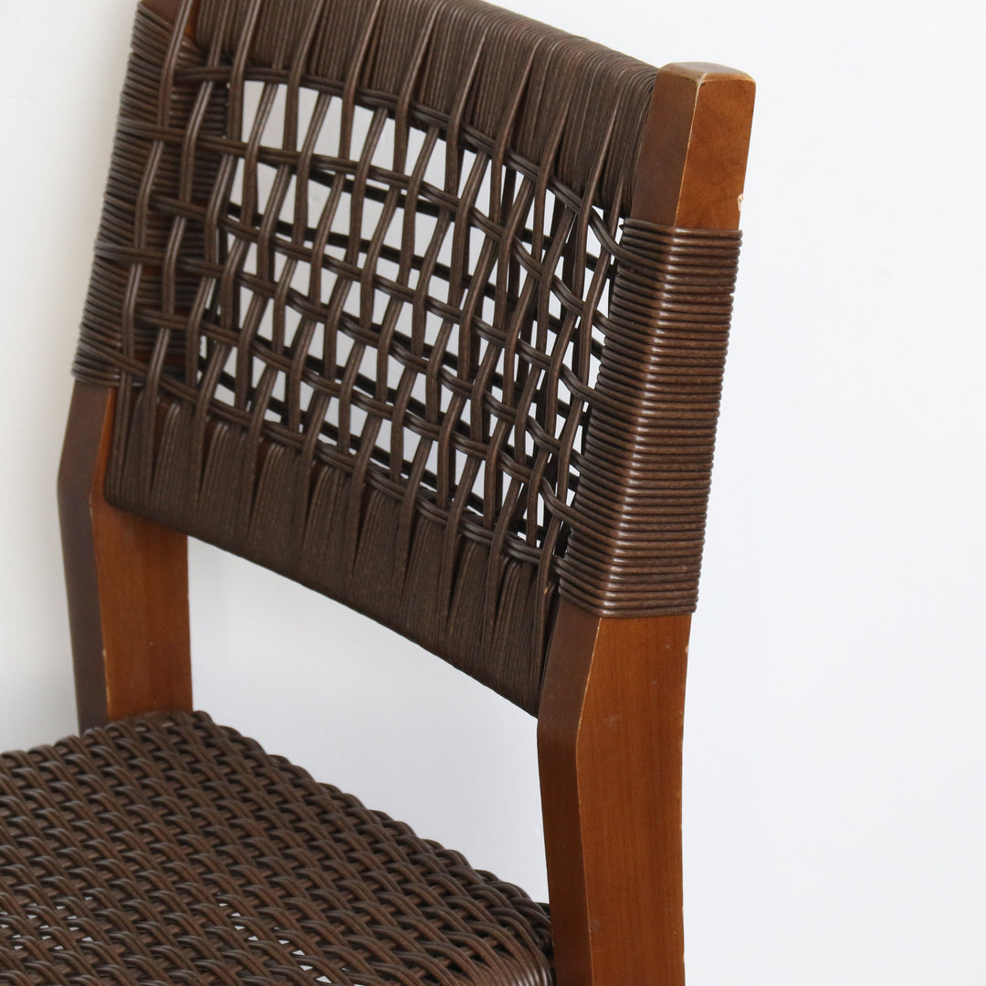 Brown wicker chair with wooden frame on a white background