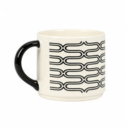 An off-white ceramic coffee mug with a glossy black handle and a black wavy chain-link pattern around the middle, set against a solid light gray background.