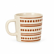 A speckled cream-colored ceramic mug with brown horizontal stripes and dotted patterns, set against a plain light gray background.
