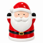 Load image into Gallery viewer, A ceramic Santa Claus figurine or container with a glossy red and white outfit, black belt, and gold buckle detail, photographed on a desk with papers and a keyboard in the background.
