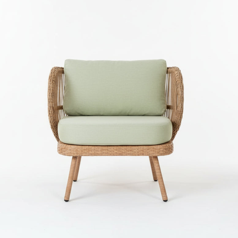 Wicker chair with green cushion on a tiled floor