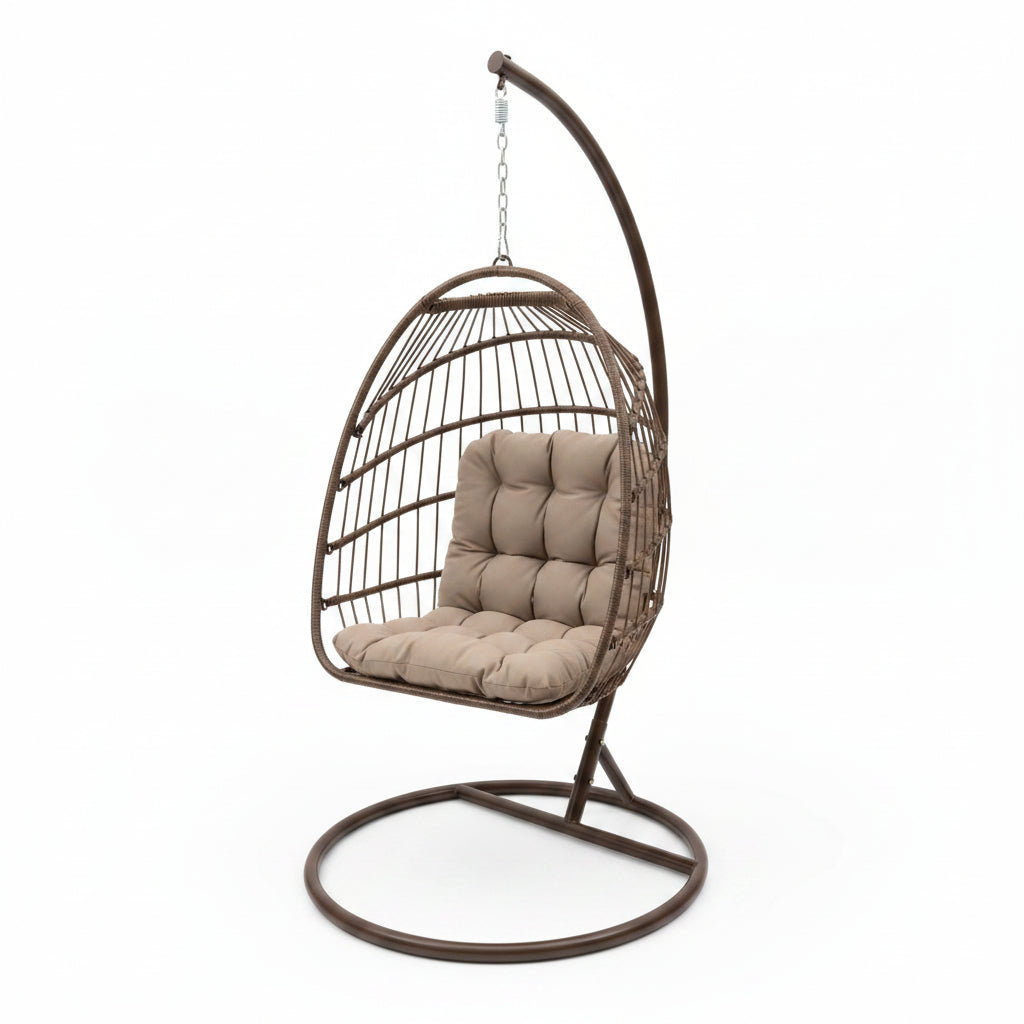 Brown hanging chair with beige cushion on a concrete floor.