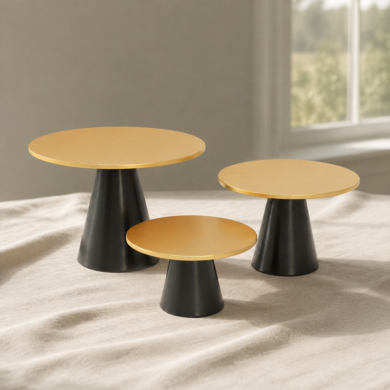 Gold Black Cake Stands displayed on a complementary linen tablecloth